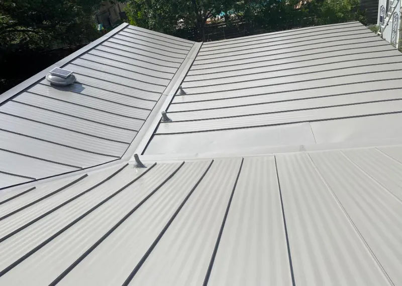 Solar attic fan installed on a metal roof for Roof Ventilation in Clermont